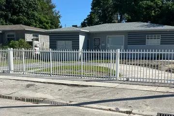 White aluminum picket fence in front of a home