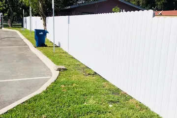 White Durafence steel privacy fence along a lawn