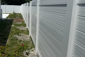 White vinyl (PVC) privacy fence along a side yard