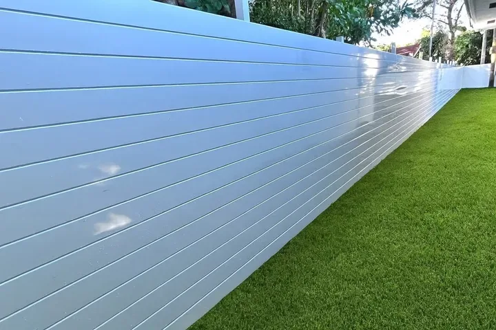 White TG Fence aluminum privacy panels along a lawn